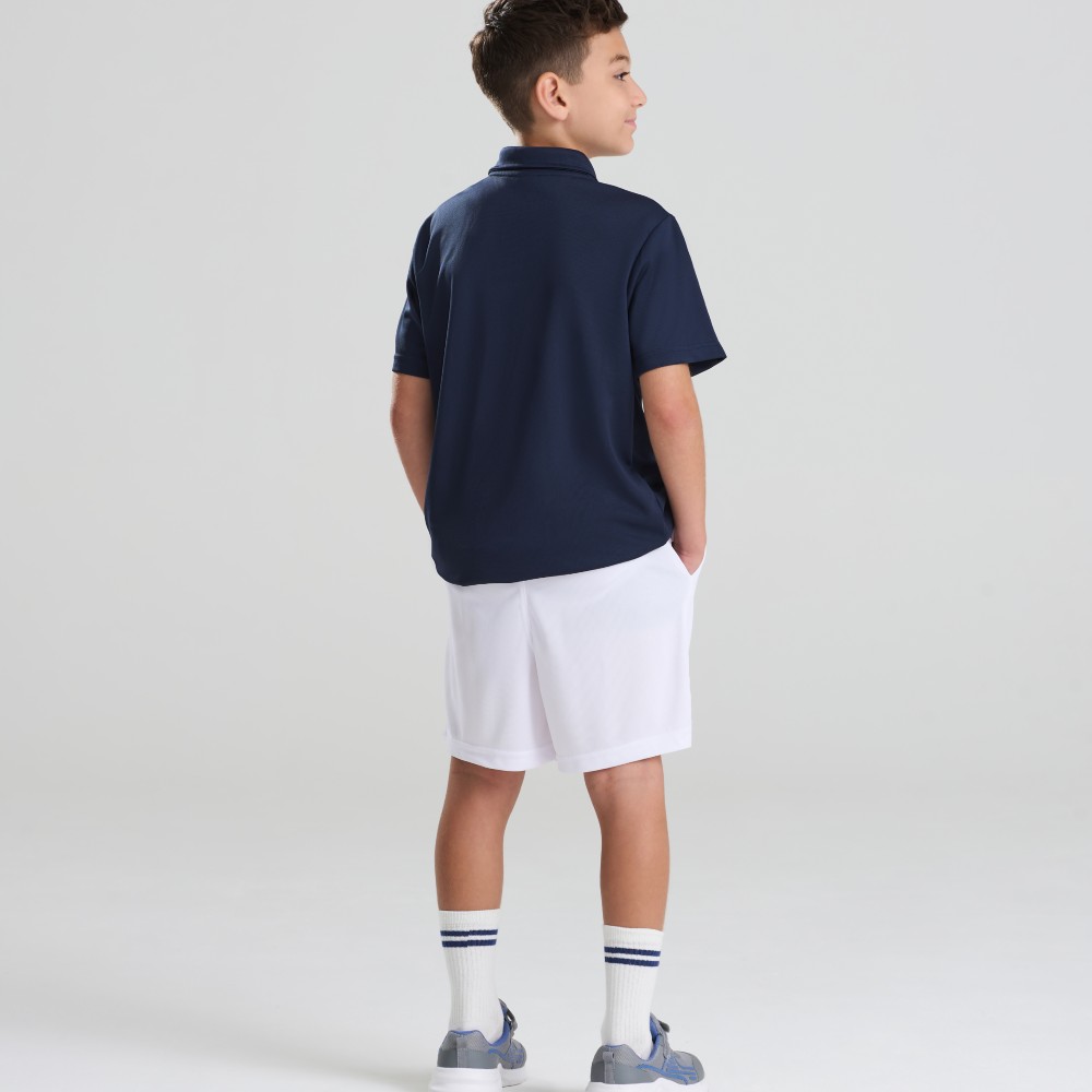 A boy with his back to the camera wearing white shorts and a drak T-shirt