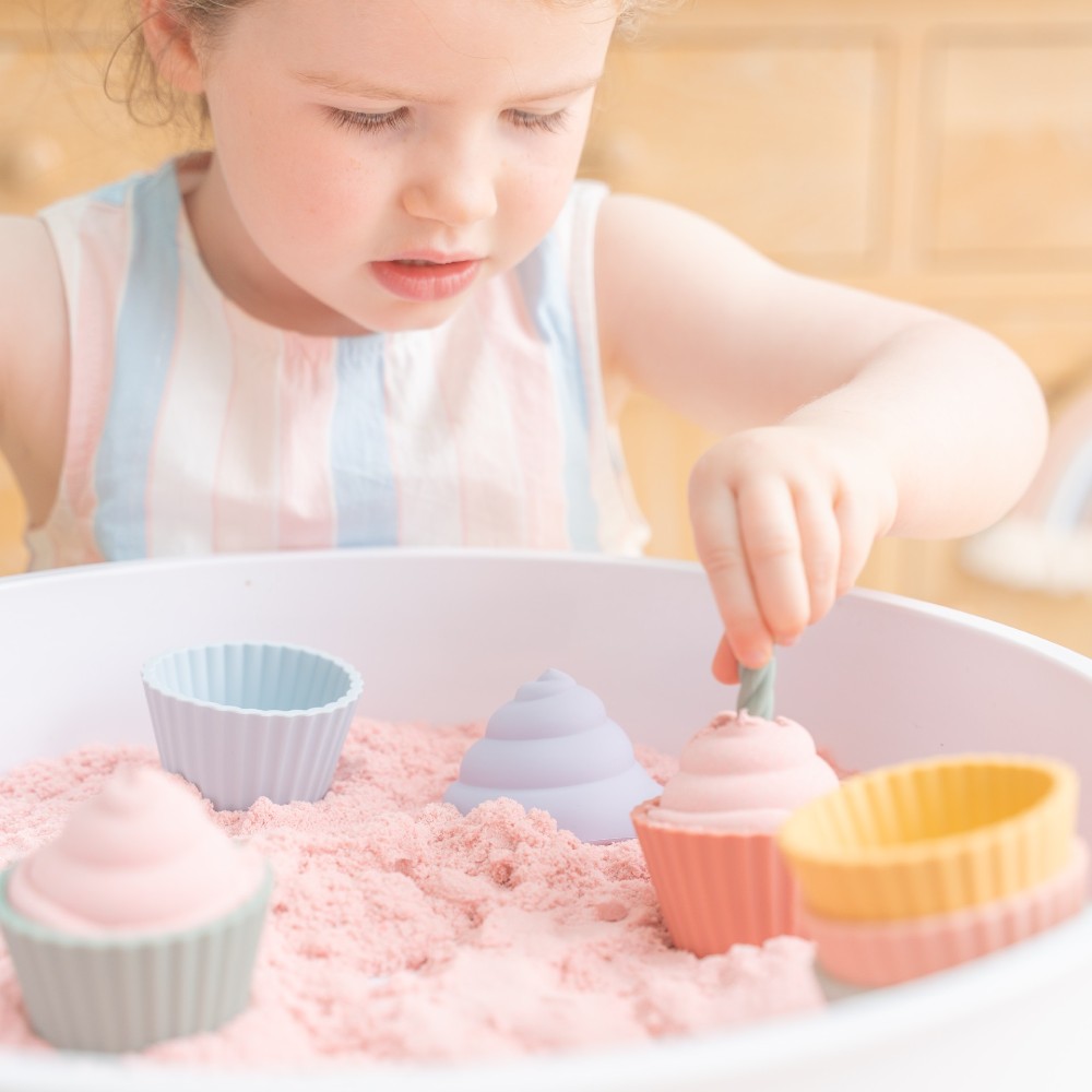 A young girl playing with the Cupcake Play Set by Inspire My Play 
