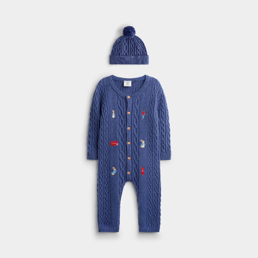 A blue knitted baby hat and all-in-one with Peter Rabbit and London themed embroideries